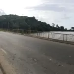 A road in Grand-Lahou bordered by a river