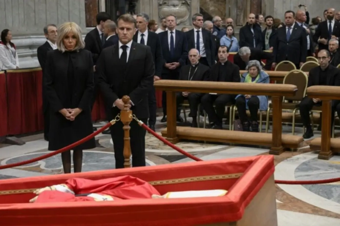 Cette photo prise et distribuée le 25 avril 2025 par The Vatican Media montre le président français Emmanuel Macron et son épouse Brigitte Macron rendant hommage au pape François à la basilique Saint-Pierre au Vatican. @ martin