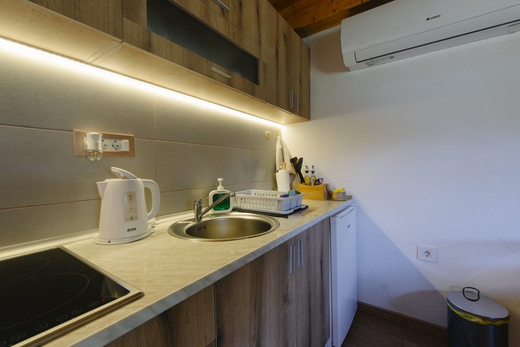 Cuisine moderne équipée de placards en bois et d’appareils électroménagers