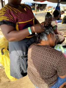 Application d’un défrisant capillaire sur les cheveux d’une femme