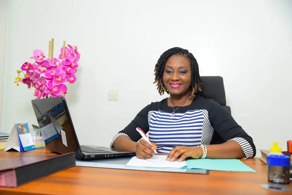 Une entrepreneure ivoirienne signe des documents dans un bureau